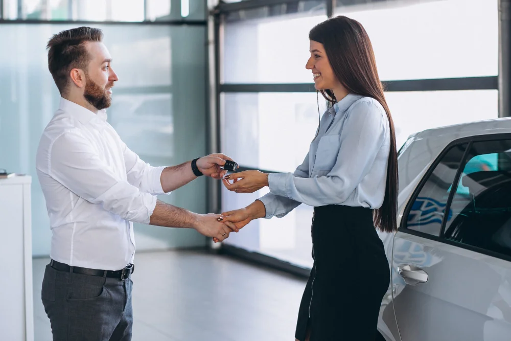 Mujer feliz al cerrar la venta de un carro